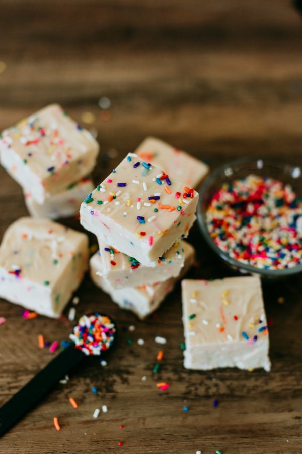 birthday cake fudge piled next to a bowl of sprinkles