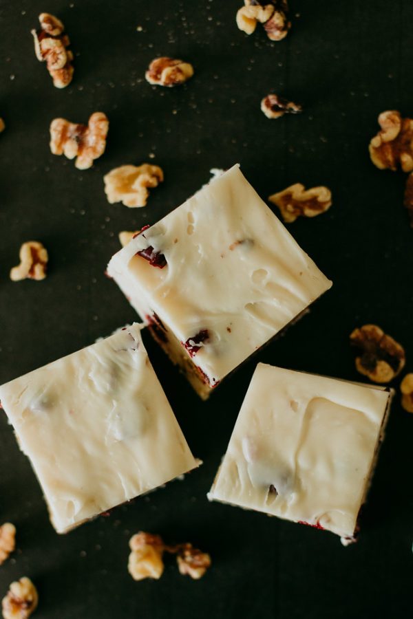 cranberry walnut fudge with walnuts scattered around
