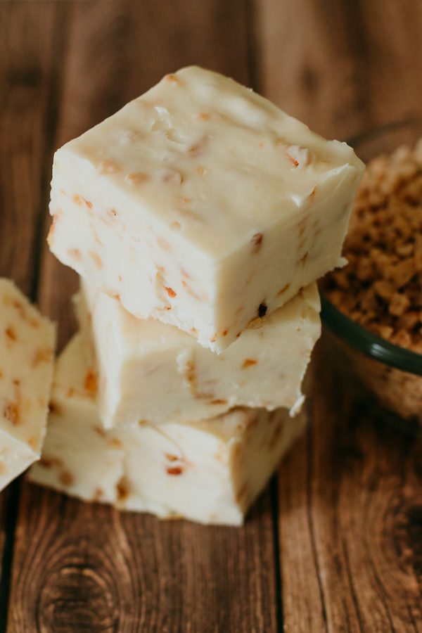 stack of health bar fudge with granola scattered on the table