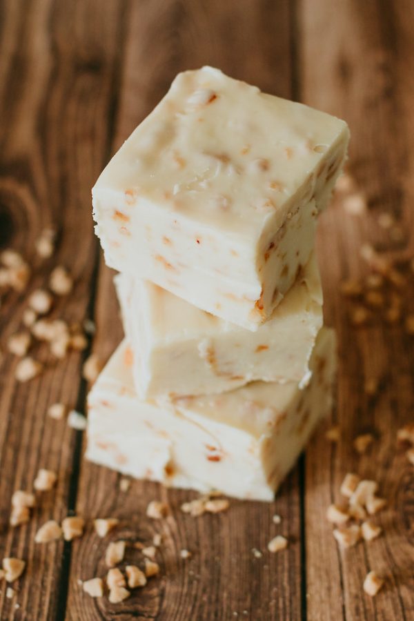 stack of health bar fudge with granola scattered on the table
