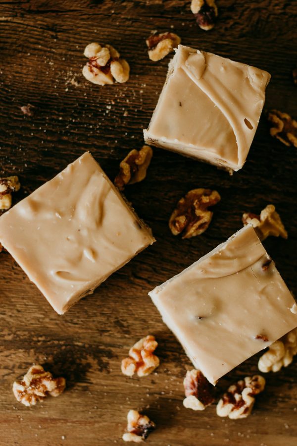 maple walnut fudge with maple soaked walnuts scattered around
