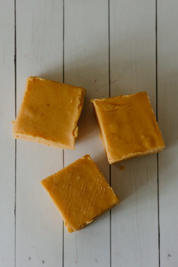 squares of pumpkin fudge on a wood table